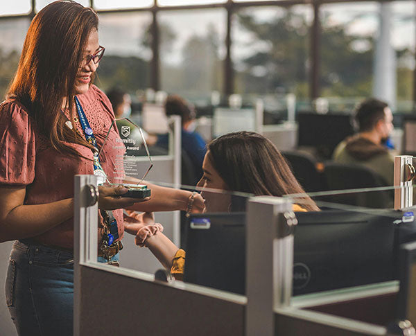 Manager handing award to employee